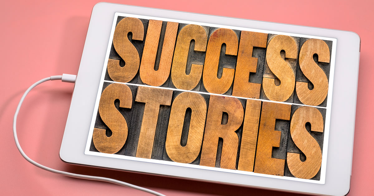 Success stories typography — word abstract in vintage letterpress wood type on a digital tablet