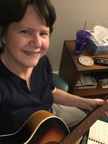Writer Gloria Rand with her guitar