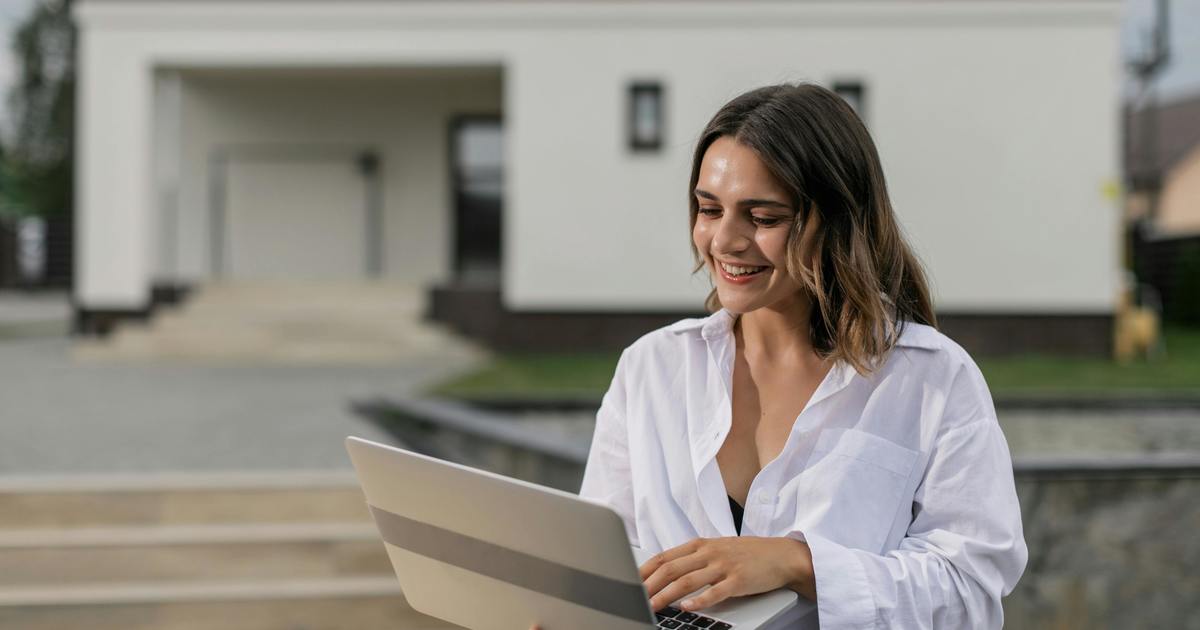 Writer holding laptop outside
